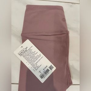 Lululemon Reveal tights. Pink. Brand new with tags. Size 4